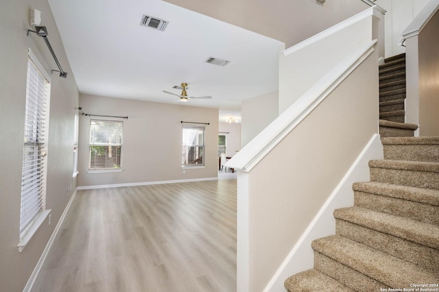 stairway featuring hardwood / wood-style floors and ceiling fan