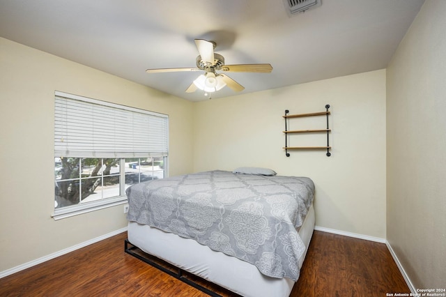 bedroom with dark wood-type flooring and ceiling fan