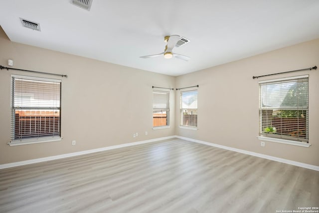 empty room featuring ceiling fan and light hardwood / wood-style flooring