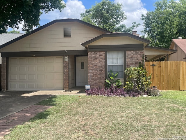 ranch-style home with a garage and a front yard