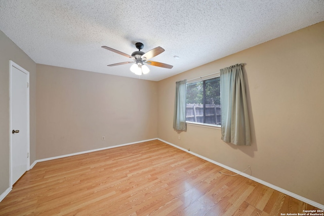 spare room with a textured ceiling, light hardwood / wood-style flooring, and ceiling fan