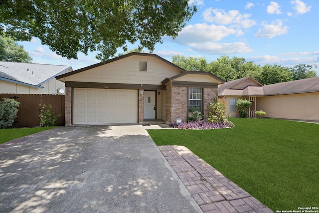 single story home with a garage and a front lawn