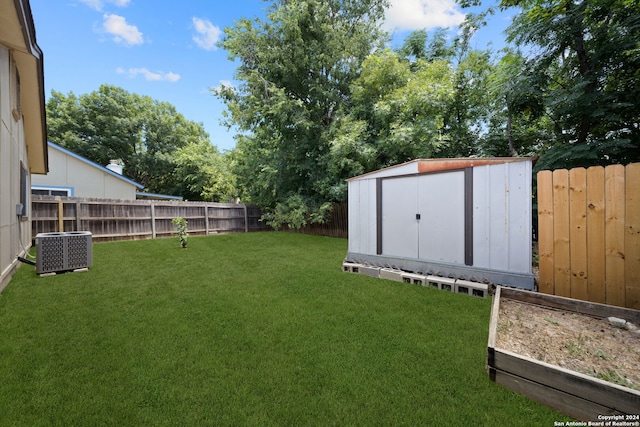 view of yard with central air condition unit and a storage unit