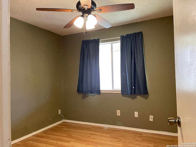 unfurnished room featuring a textured ceiling, ceiling fan, and hardwood / wood-style floors