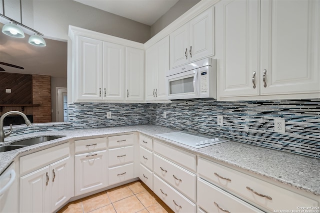 kitchen with sink, white appliances, and white cabinets