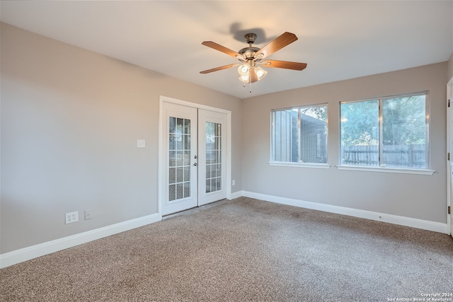 unfurnished room featuring ceiling fan, french doors, and carpet floors