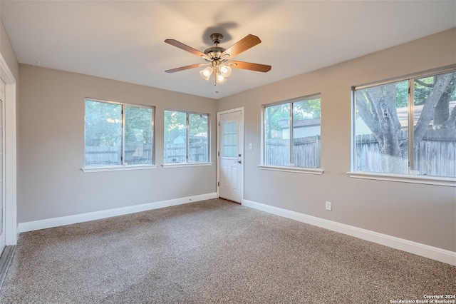 unfurnished room with carpet floors and ceiling fan