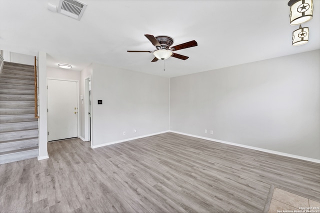 unfurnished living room with light wood-type flooring and ceiling fan