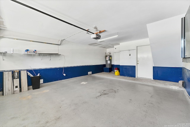 garage featuring electric water heater and a garage door opener