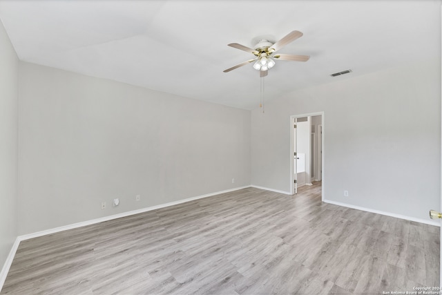 empty room featuring light hardwood / wood-style floors, ceiling fan, and lofted ceiling