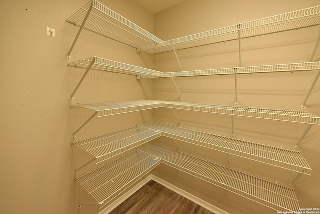 unfurnished room with ceiling fan, light wood-type flooring, and vaulted ceiling