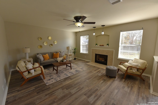 living room featuring a fireplace, dark hardwood / wood-style floors, and ceiling fan