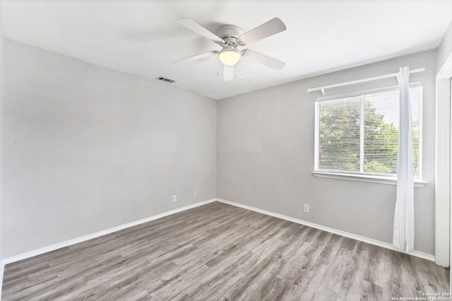 empty room featuring ceiling fan and light hardwood / wood-style flooring