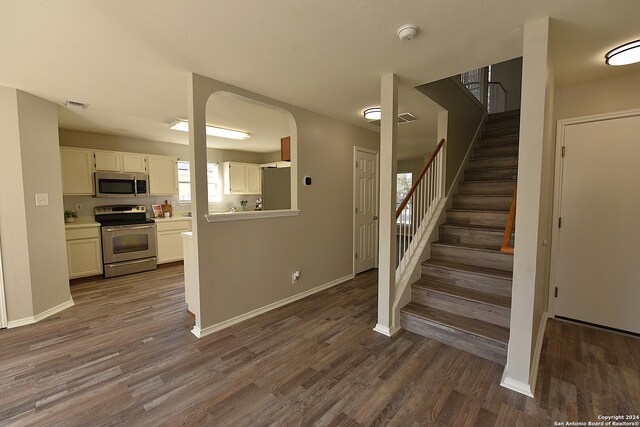 clothes washing area with electric dryer hookup, gas dryer hookup, washer hookup, and wood-type flooring