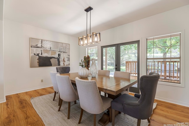 dining area featuring a chandelier and light wood-type flooring