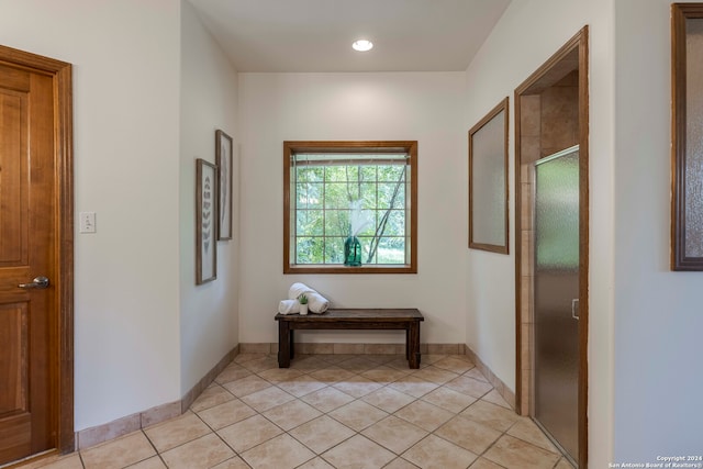 hall with light tile patterned floors