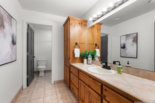 bathroom featuring tile patterned floors, vanity, and toilet