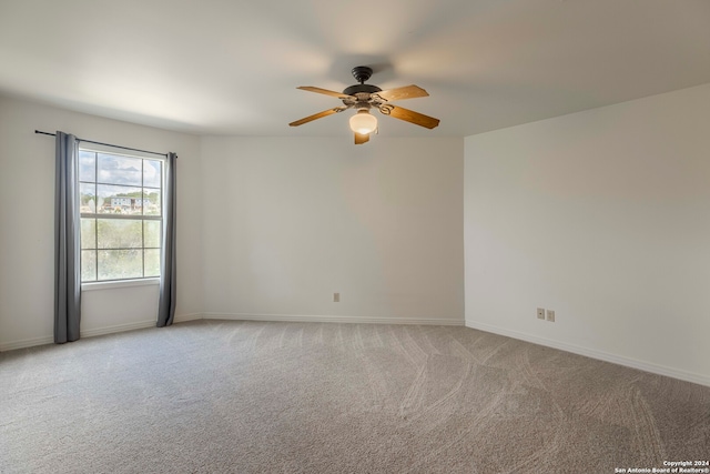 unfurnished room with carpet and ceiling fan