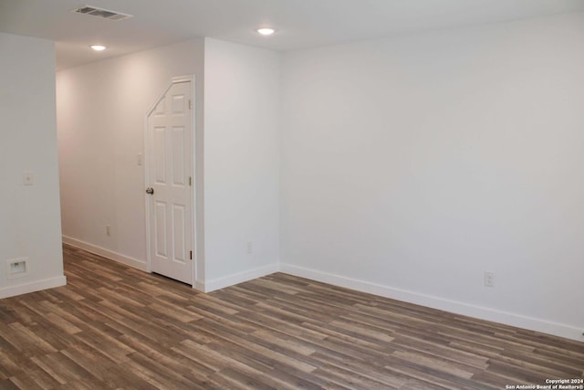 empty room featuring dark wood-type flooring