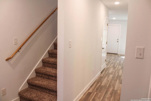 stairway featuring hardwood / wood-style flooring