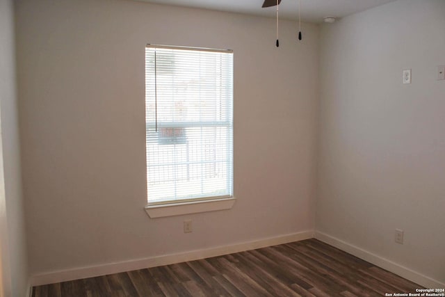 unfurnished room with dark wood-type flooring