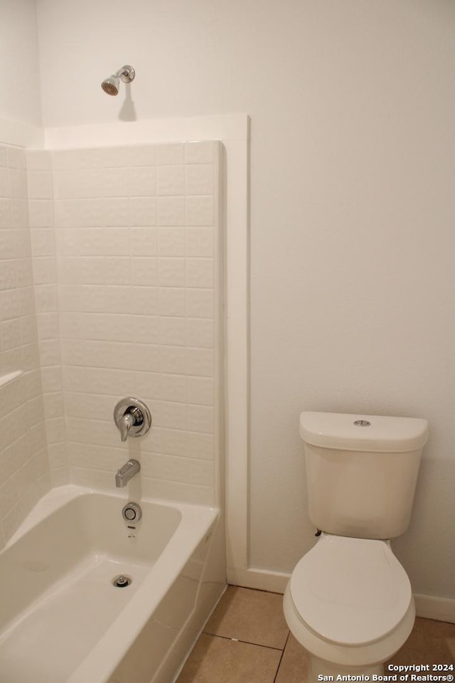 bathroom with tile patterned flooring, shower / bathtub combination, and toilet