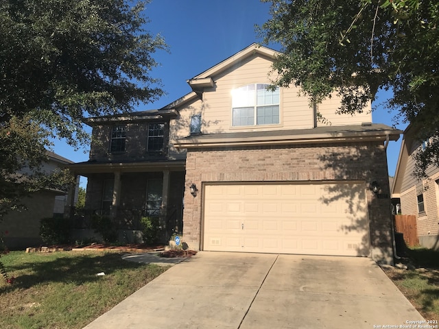 front of property featuring a garage and a front lawn