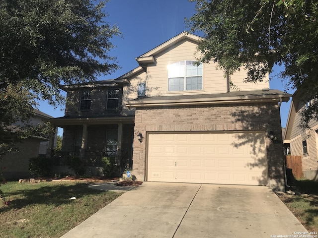 traditional home with concrete driveway and an attached garage