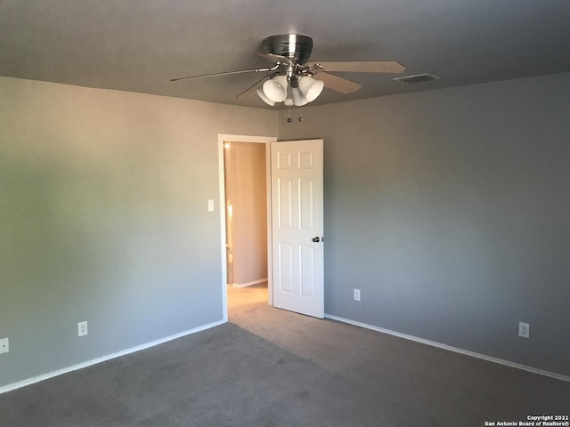 unfurnished room featuring visible vents, carpet flooring, a ceiling fan, and baseboards