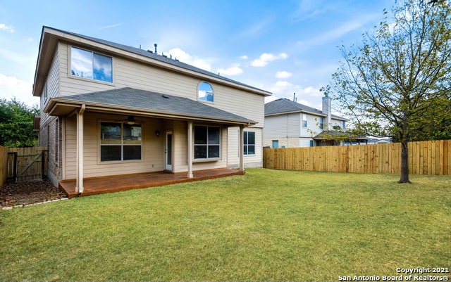 back of property featuring a patio and a yard