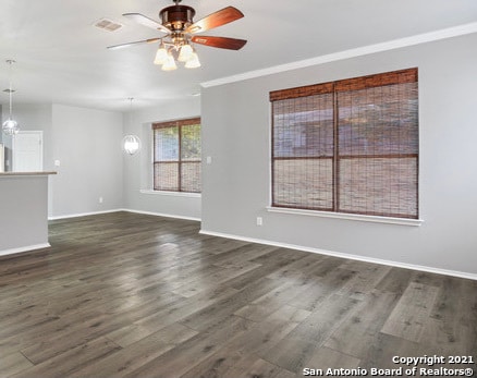 unfurnished living room with dark hardwood / wood-style flooring, ceiling fan, and crown molding