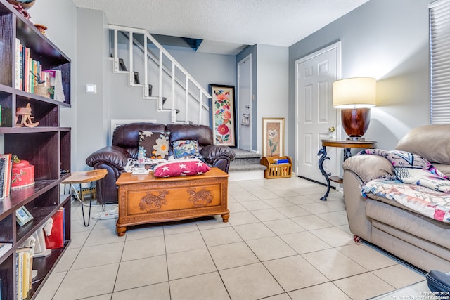 living room with tile patterned floors and a textured ceiling