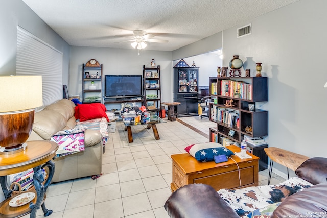 tiled living room featuring a textured ceiling and ceiling fan