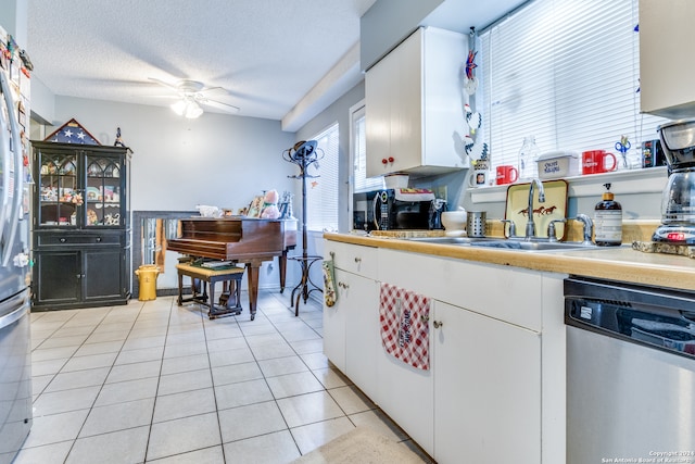 kitchen with a textured ceiling, white cabinets, ceiling fan, stainless steel dishwasher, and sink