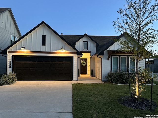 modern farmhouse with a garage and a front lawn