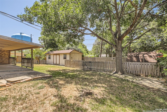 view of yard featuring a storage unit and a patio area