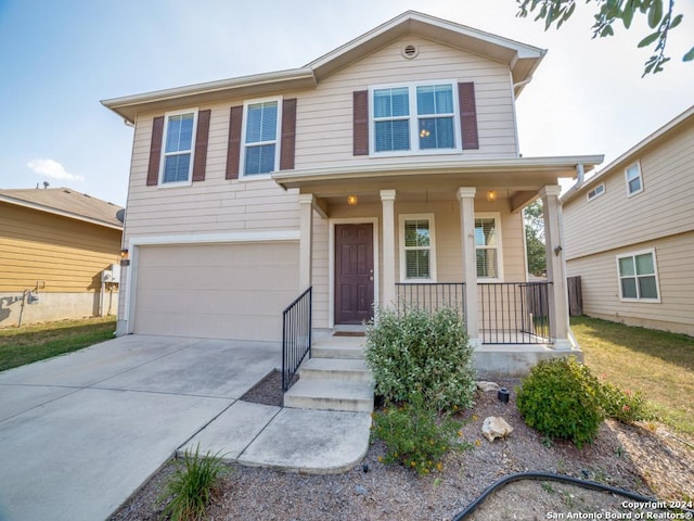 view of front of property with a garage and covered porch