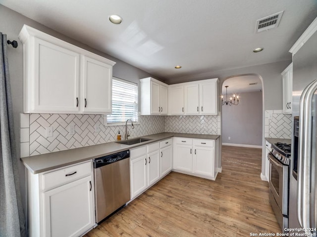 kitchen featuring stainless steel appliances, light hardwood / wood-style flooring, white cabinets, and sink