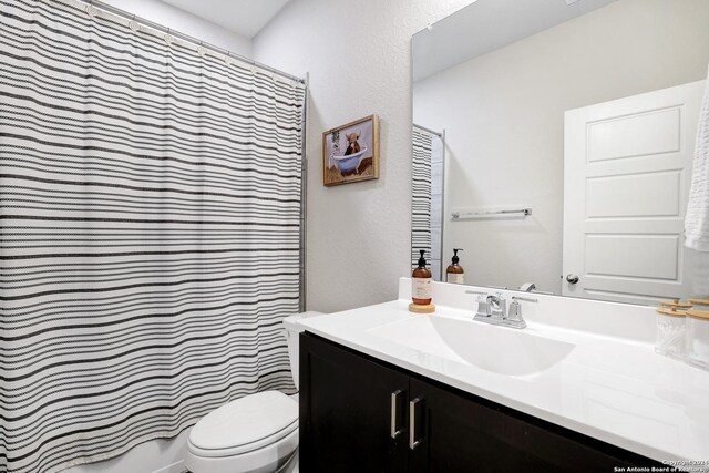 bathroom featuring vanity, a shower with curtain, and toilet