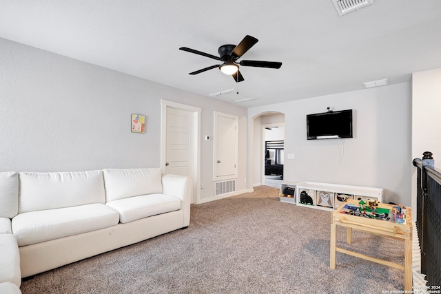 carpeted living room with ceiling fan