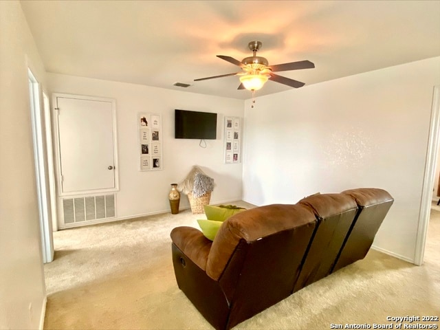 living room with carpet flooring and ceiling fan