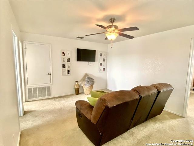 25231 Cambridge Wl, San Antonio, TX 78261 - living area with carpet, a ceiling fan, and baseboards