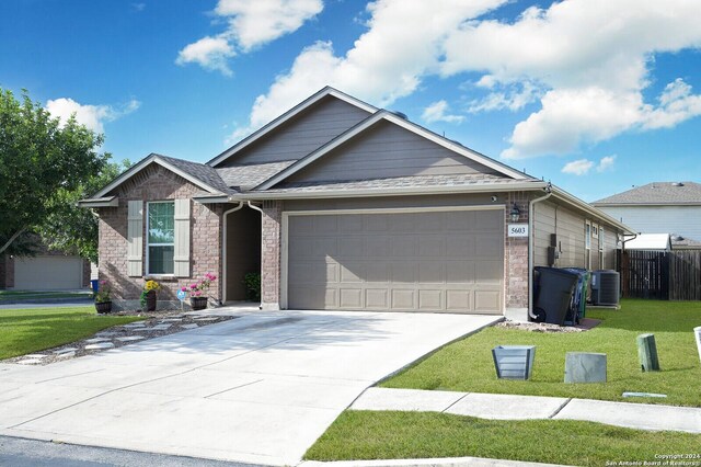 craftsman-style home with a garage, central air condition unit, and a front lawn