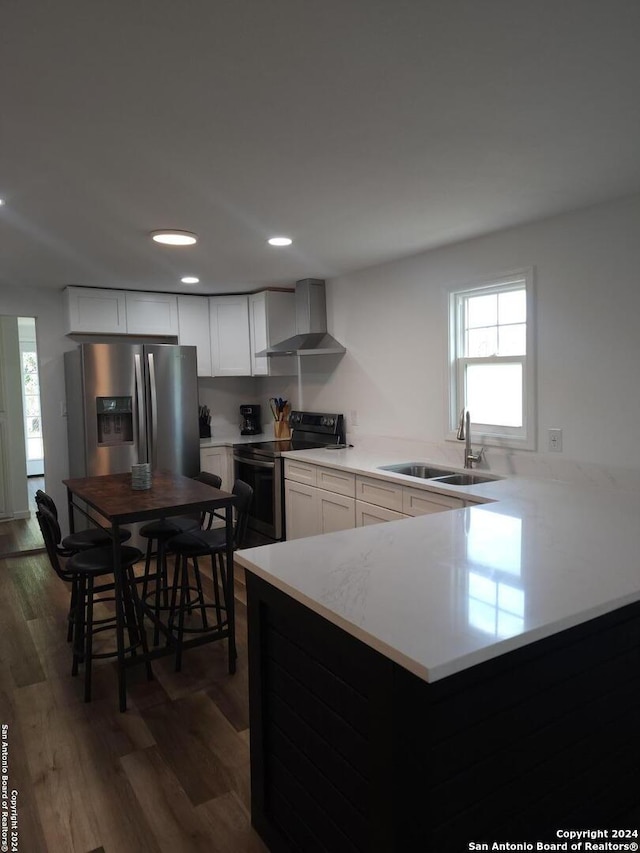 kitchen with dark hardwood / wood-style flooring, stainless steel refrigerator with ice dispenser, wall chimney exhaust hood, and electric range oven