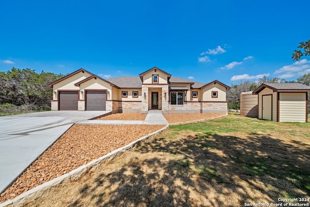 view of front of home with a garage, a storage shed, and a front lawn