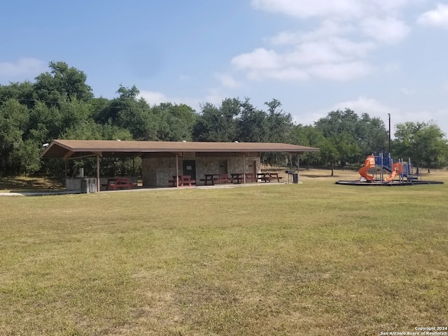 view of community featuring a lawn and a playground