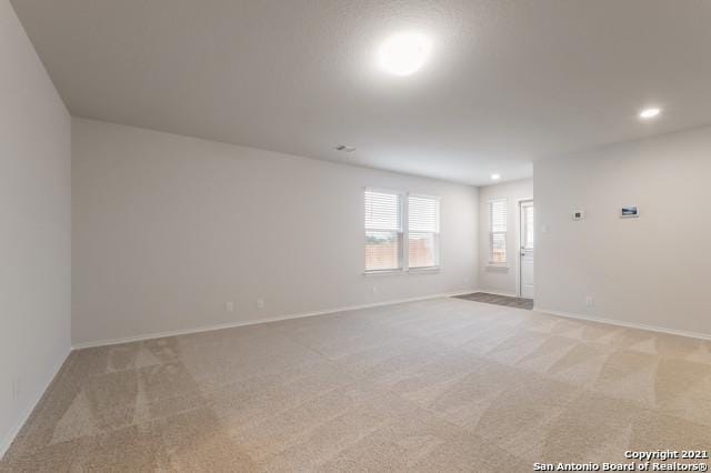 unfurnished room with light carpet