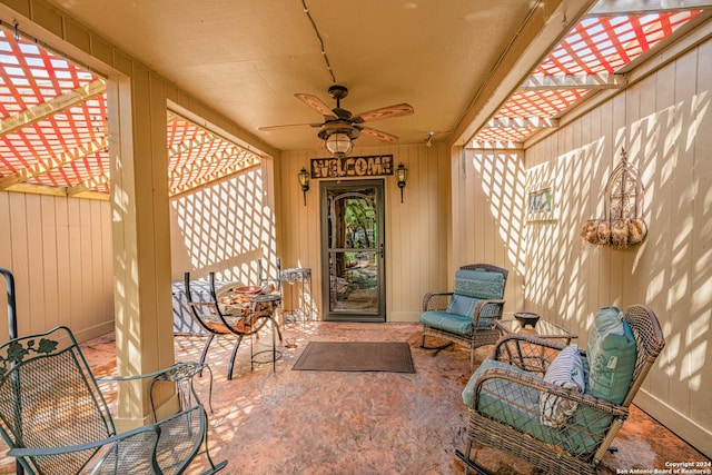 entrance to property with a patio and ceiling fan