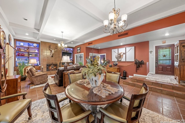 dining area with tile patterned flooring, beam ceiling, tile walls, coffered ceiling, and a tile fireplace