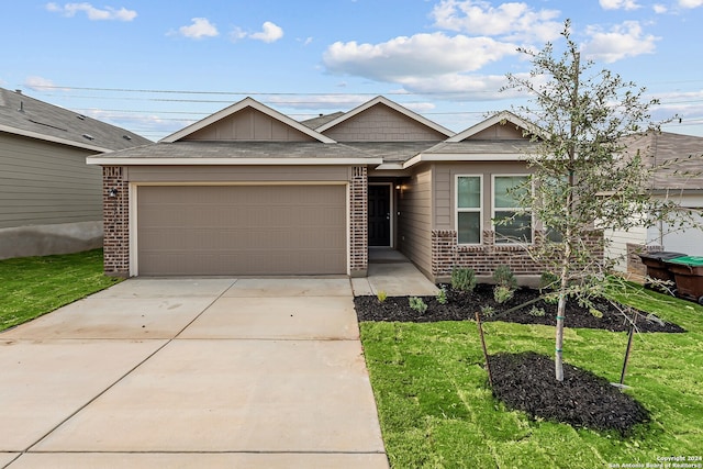 view of front facade featuring a garage and a front lawn